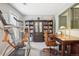 Bonus room with desk area and exercise equipment features built-in bookshelves at 1582 W Briarwood Ave, Littleton, CO 80120