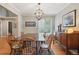 Bright dining room featuring hardwood floors, buffet cabinet, and lots of natural light from the window at 1582 W Briarwood Ave, Littleton, CO 80120