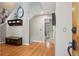 Spacious entryway with hardwood floors, storage bench and decorative shelves, offering a welcoming first impression at 1582 W Briarwood Ave, Littleton, CO 80120