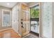 Inviting entryway featuring a beautiful wood door and decorative glass, leading to a bright and welcoming home at 1582 W Briarwood Ave, Littleton, CO 80120
