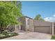 Two-story home with a deck, two-car garage and a combination of stone and wood siding at 1582 W Briarwood Ave, Littleton, CO 80120