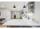 Bright, remodeled kitchen featuring white countertops, gray cabinets and modern pendant lighting at 1582 W Briarwood Ave, Littleton, CO 80120