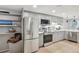 Modern kitchen featuring stainless steel appliances, ample gray cabinetry and bright countertops at 1582 W Briarwood Ave, Littleton, CO 80120