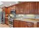 Updated kitchen featuring stainless steel appliances, granite countertops, and ample cabinet space for storage at 1582 W Briarwood Ave, Littleton, CO 80120