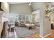 Bright living room featuring high ceilings, hardwood floors, and large windows at 1582 W Briarwood Ave, Littleton, CO 80120