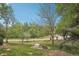 View of a grassy front yard with mature trees near a quiet street at 1582 W Briarwood Ave, Littleton, CO 80120