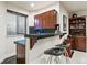 Basement bar featuring dark granite countertops, dark wood cabinets, and two bar stools at 168 S Garfield St, Denver, CO 80209