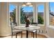 Eating nook area with a round table, seating, and large windows to the backyard at 168 S Garfield St, Denver, CO 80209