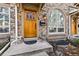 Charming front entrance with a wood door, stone accents, and decorative lighting, plus a friendly 'welcome' at 168 S Garfield St, Denver, CO 80209
