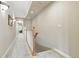 Hallway with wood railing, neutral walls and carpet, and overhead recessed lighting at 168 S Garfield St, Denver, CO 80209