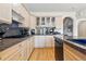 An open kitchen features maple cabinets, granite countertops, and modern stainless steel appliances at 168 S Garfield St, Denver, CO 80209