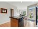 A kitchen with wood cabinets, a center island, and a door leading to the backyard at 168 S Garfield St, Denver, CO 80209