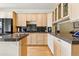 A kitchen with maple cabinetry, granite countertops, and stainless steel appliances at 168 S Garfield St, Denver, CO 80209
