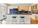 An open kitchen with wooden cabinets, granite countertops, and a breakfast bar area with stools at 168 S Garfield St, Denver, CO 80209