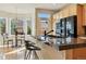 Open kitchen showcasing granite counters, wooden cabinets, and a breakfast bar near the eating nook at 168 S Garfield St, Denver, CO 80209