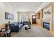 Spacious living room featuring plush carpet, fireplace, and access to other rooms, ideal for Gathering gatherings at 168 S Garfield St, Denver, CO 80209