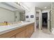 Bright bathroom with double sinks, tiled floors, and plenty of natural light at 168 S Garfield St, Denver, CO 80209