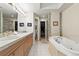 Large main bathroom with tiled flooring, double sinks and a soaking tub at 168 S Garfield St, Denver, CO 80209