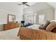This primary bedroom features plush carpet, neutral walls and a sitting area by the bay windows at 168 S Garfield St, Denver, CO 80209