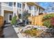 Back patio featuring outdoor seating, BBQ grill, privacy fence, a rock water feature, and green landscaping at 168 S Garfield St, Denver, CO 80209