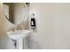 Bright powder room featuring a pedestal sink with modern fixtures and an oval mirror at 168 S Garfield St, Denver, CO 80209