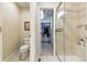 Bright bathroom featuring a toilet, shower, and walk-in closet at 168 S Garfield St, Denver, CO 80209
