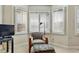 Bright sitting area with large bay windows and neutral walls, complete with a comfortable chair at 168 S Garfield St, Denver, CO 80209