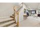 View of basement staircase with carpeted stairs and wooden railing, and a carpeted basement at 168 S Garfield St, Denver, CO 80209