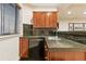 This basement wet bar boasts granite countertops, tiled backsplash, and wooden cabinets at 168 S Garfield St, Denver, CO 80209