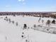 Aerial view of a snow covered park and residential area at 2615 N Steele St, Denver, CO 80205