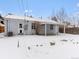 Backyard view of home with covered patio and snowy landscape at 2615 N Steele St, Denver, CO 80205