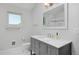 Bathroom with marble vanity, tiled shower, and modern fixtures at 2615 N Steele St, Denver, CO 80205