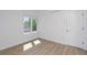 Well-lit bedroom featuring hardwood floors and a window at 2615 N Steele St, Denver, CO 80205