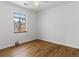 Spacious bedroom with hardwood floors and large window at 2615 N Steele St, Denver, CO 80205