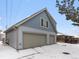 Two-car garage with dormer windows and light gray siding at 2615 N Steele St, Denver, CO 80205