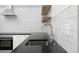 Modern kitchen features a sleek sink, updated appliances, and stylish backsplash at 2615 N Steele St, Denver, CO 80205