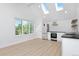 Modern kitchen with skylights, stainless steel appliances, and island at 2615 N Steele St, Denver, CO 80205