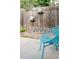 Intimate backyard patio with a comfortable blue chair and decorative vases mounted on a wooden fence at 1338 S Fairfax St, Denver, CO 80222