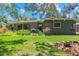 Charming home with manicured lawn, mature trees, and inviting backyard patio at 1338 S Fairfax St, Denver, CO 80222