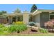 Outdoor space with patio dining set, well maintained garden beds and greenery at 1338 S Fairfax St, Denver, CO 80222