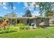 Charming home with manicured lawn, mature trees, and inviting backyard patio at 1338 S Fairfax St, Denver, CO 80222