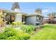 Well-manicured backyard featuring a vibrant patio set, a grassy lawn, and a professionally landscaped garden at 1338 S Fairfax St, Denver, CO 80222