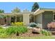 Landscaped backyard with a patio area, modern patio furniture, and views of the green lawn and trees at 1338 S Fairfax St, Denver, CO 80222