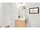 Bathroom featuring a floating vanity, gold hardware, and a framed art piece at 1338 S Fairfax St, Denver, CO 80222