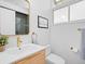 Bright bathroom featuring a modern vanity, gold hardware, and stylish decor at 1338 S Fairfax St, Denver, CO 80222
