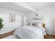Bright bedroom with a white wood-beamed ceiling, wood floors, and an area rug at 1338 S Fairfax St, Denver, CO 80222