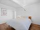 Bedroom with hardwood floors, white walls, and a bed with patterned bedding at 1338 S Fairfax St, Denver, CO 80222