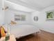 Bedroom with hardwood floors, white walls, recessed lighting, and large windows providing natural light at 1338 S Fairfax St, Denver, CO 80222