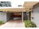 The carport is attached to the house and contains a storage area, along with access to the front door at 1338 S Fairfax St, Denver, CO 80222