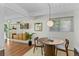 Cozy dining area featuring hardwood floors, stylish decor, and ample natural light from a window at 1338 S Fairfax St, Denver, CO 80222